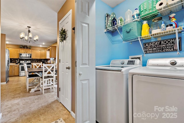 washroom with separate washer and dryer and an inviting chandelier