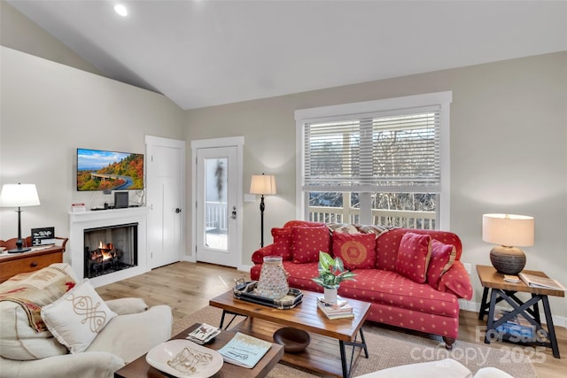 living room with light hardwood / wood-style flooring and lofted ceiling