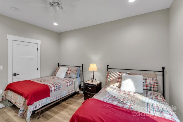 bedroom with ceiling fan and light hardwood / wood-style flooring