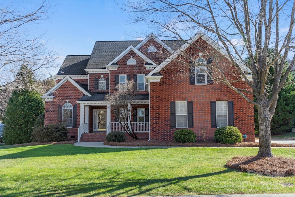 view of front of home with covered porch and a front yard