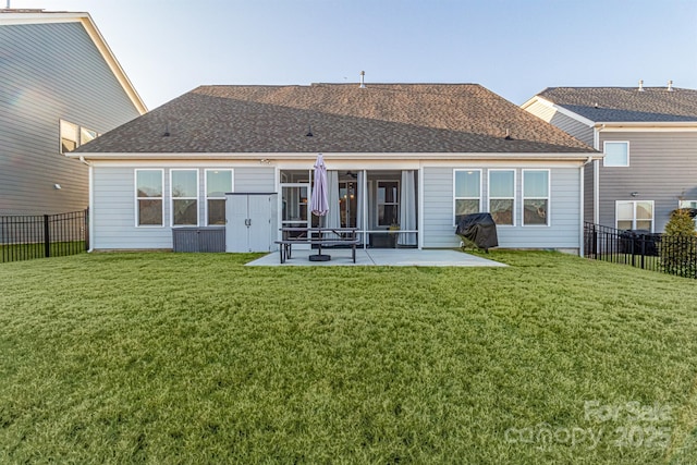 back of house featuring a patio area and a lawn