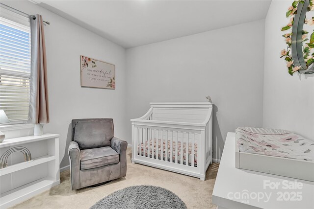 bedroom with a nursery area and light colored carpet