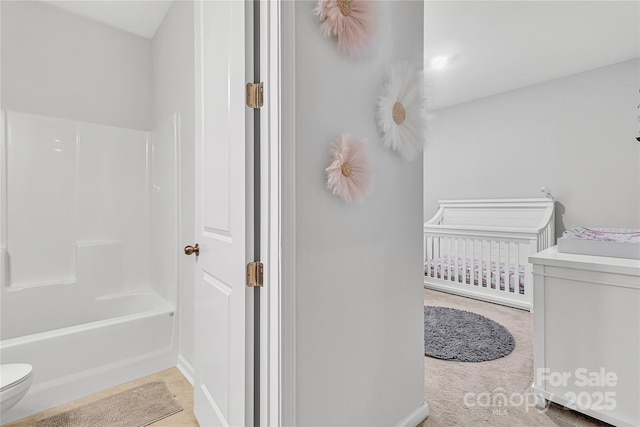 bathroom featuring toilet and shower / bathing tub combination