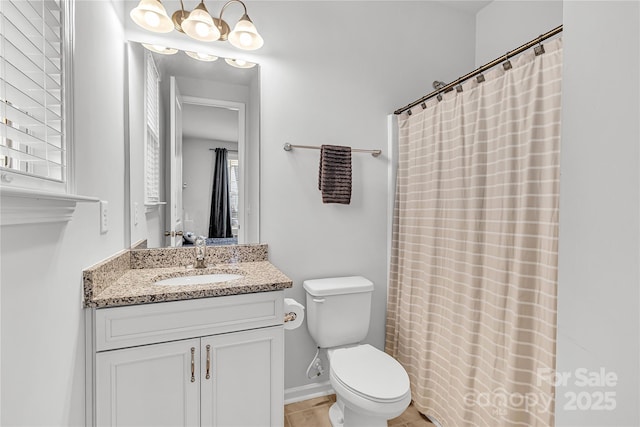 bathroom with toilet, vanity, and a shower with curtain