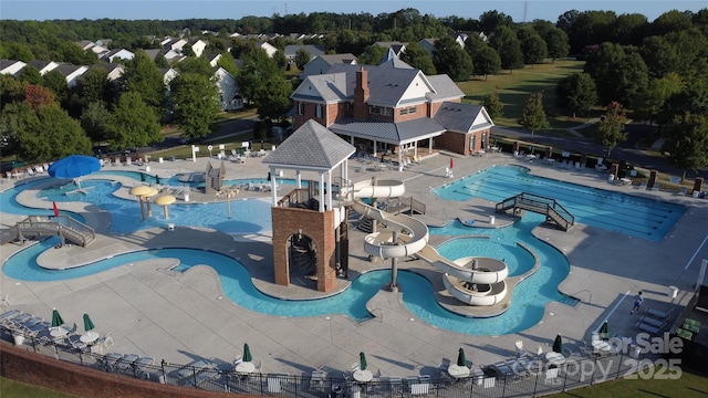 view of swimming pool featuring a patio and a water slide