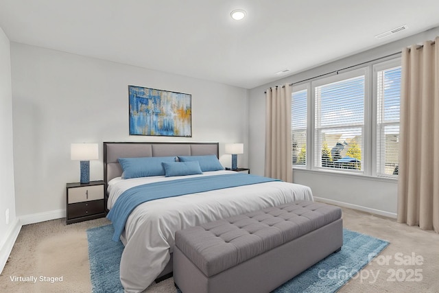 bedroom featuring multiple windows and light colored carpet