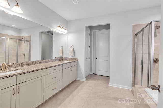 bathroom featuring vanity, tile patterned flooring, and walk in shower