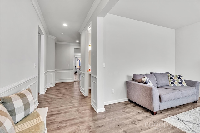 living room featuring light hardwood / wood-style flooring and crown molding