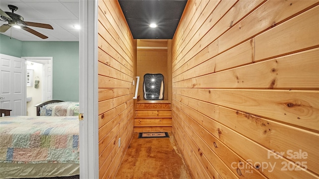 corridor featuring carpet and wooden walls