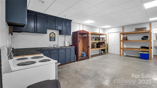 kitchen featuring blue cabinetry, electric range, a paneled ceiling, and sink