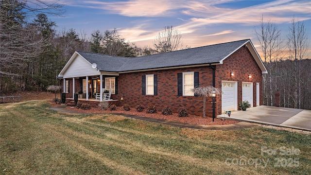 view of front of home with covered porch and a yard