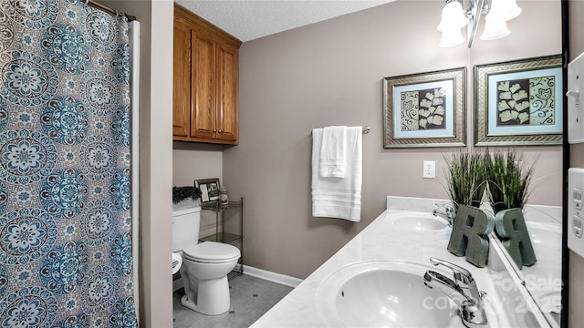 bathroom with vanity, toilet, a textured ceiling, a notable chandelier, and curtained shower