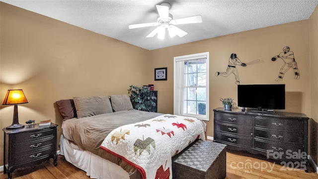 bedroom featuring a textured ceiling, light hardwood / wood-style flooring, and ceiling fan