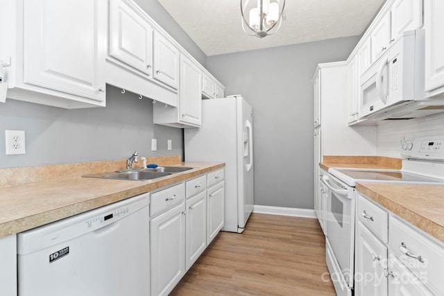 kitchen with a textured ceiling, white cabinetry, sink, and white appliances