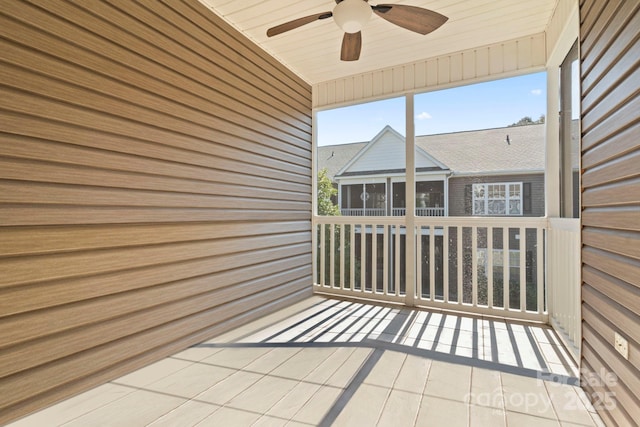 unfurnished sunroom featuring ceiling fan