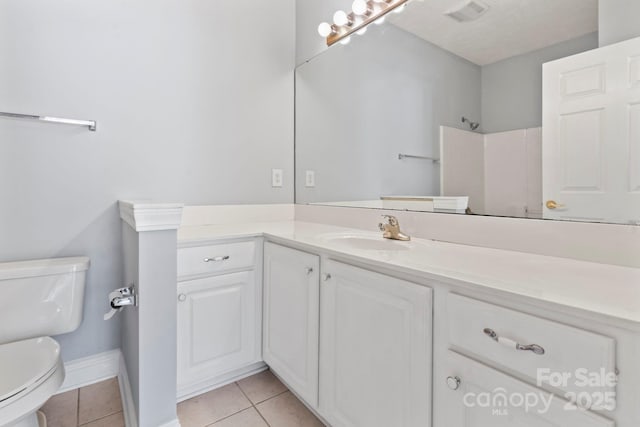 bathroom featuring tile patterned floors, a shower, vanity, and toilet