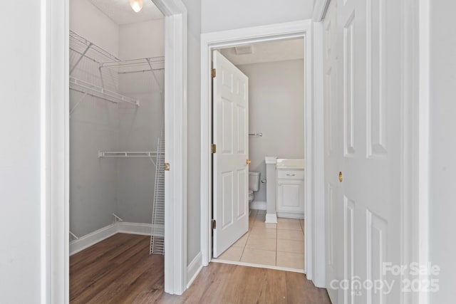 interior space featuring wood-type flooring and toilet