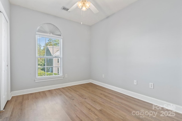 spare room with ceiling fan and light wood-type flooring