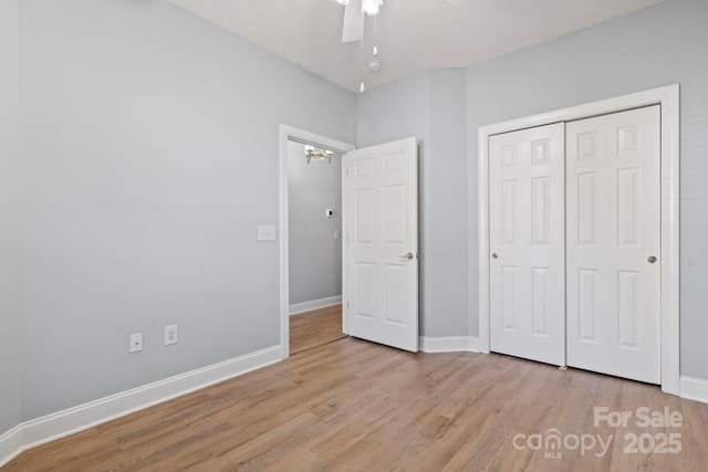 unfurnished bedroom featuring light wood-type flooring, a closet, and ceiling fan