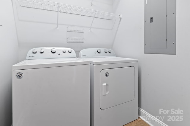 laundry area featuring electric panel and separate washer and dryer