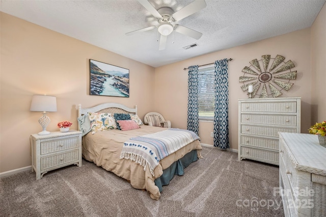 carpeted bedroom with ceiling fan and a textured ceiling