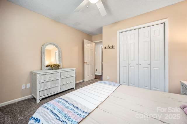 bedroom featuring dark colored carpet, a textured ceiling, a closet, and ceiling fan