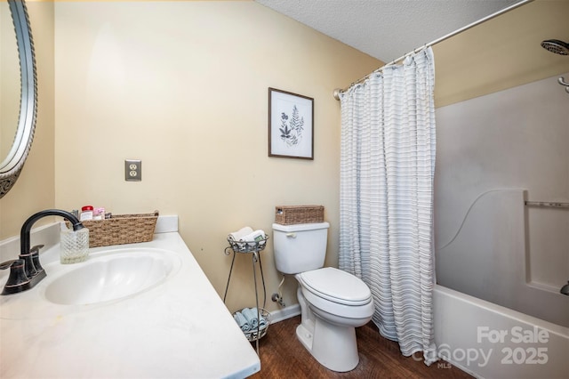 full bathroom with vanity, toilet, shower / bath combo with shower curtain, a textured ceiling, and wood-type flooring