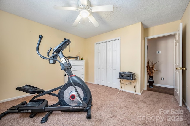 workout room with carpet, ceiling fan, and a textured ceiling