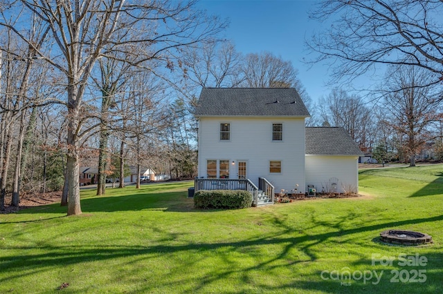 back of property featuring a yard and a deck