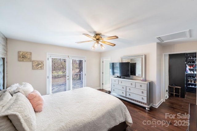 bedroom featuring dark hardwood / wood-style flooring, ceiling fan, and access to outside