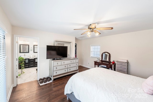 bedroom with ceiling fan, dark hardwood / wood-style flooring, and ensuite bathroom