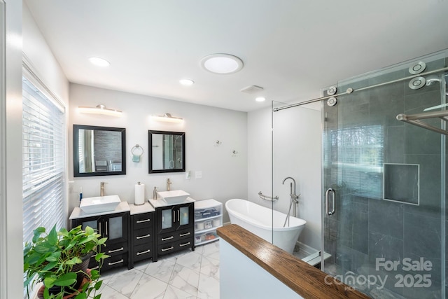 bathroom with vanity and independent shower and bath