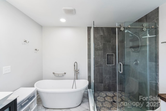 bathroom featuring shower with separate bathtub and vanity