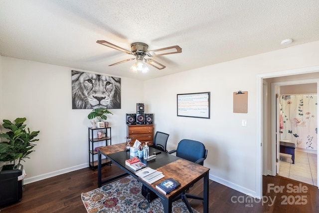 office area featuring a textured ceiling, ceiling fan, and dark hardwood / wood-style flooring