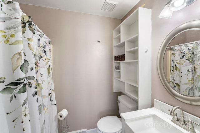 bathroom featuring toilet and vanity