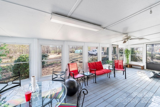 sunroom / solarium featuring ceiling fan