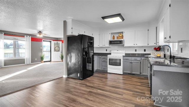 kitchen with ceiling fan, sink, white electric range, dark hardwood / wood-style flooring, and black fridge with ice dispenser