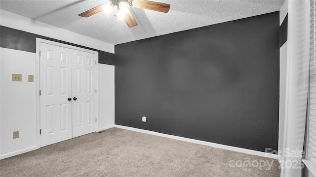 unfurnished bedroom with light carpet, a textured ceiling, a closet, and ceiling fan