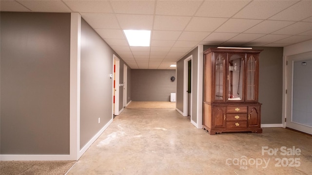 corridor featuring a paneled ceiling