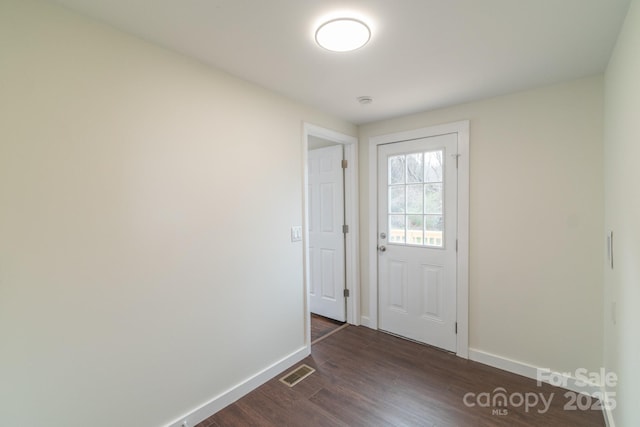 doorway with dark hardwood / wood-style floors