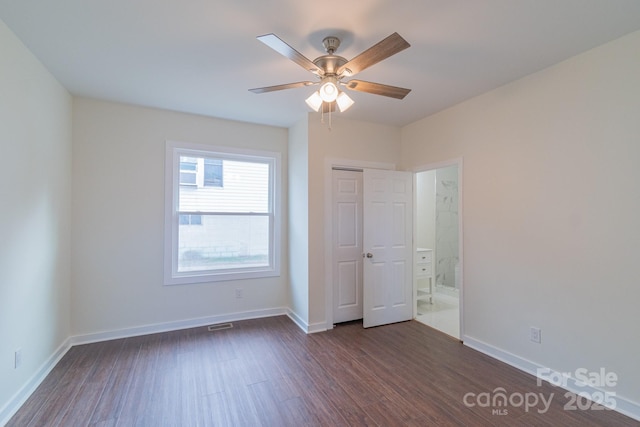 unfurnished bedroom featuring ceiling fan and dark hardwood / wood-style flooring