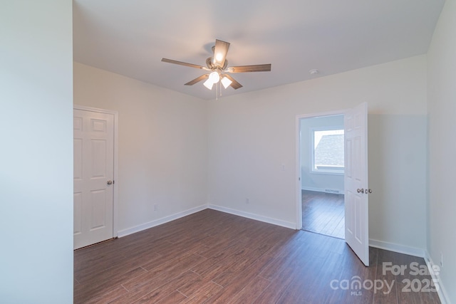 unfurnished room featuring dark hardwood / wood-style floors and ceiling fan