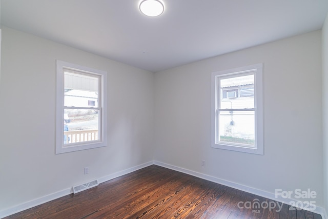 spare room with dark wood-type flooring