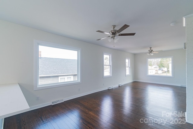 unfurnished room with ceiling fan and dark hardwood / wood-style floors