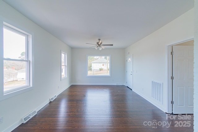 spare room featuring ceiling fan and dark hardwood / wood-style flooring