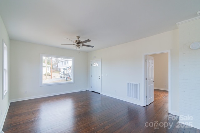 spare room with ceiling fan and dark wood-type flooring