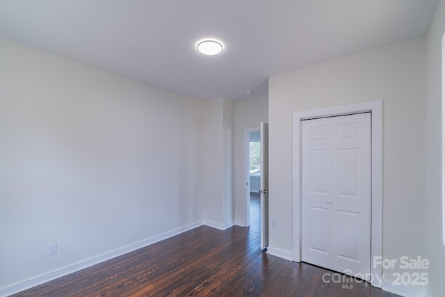 spare room featuring dark wood-type flooring