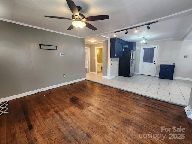 unfurnished living room featuring ceiling fan, ornamental molding, light hardwood / wood-style flooring, and track lighting