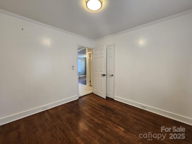 unfurnished room featuring dark hardwood / wood-style flooring and ornamental molding