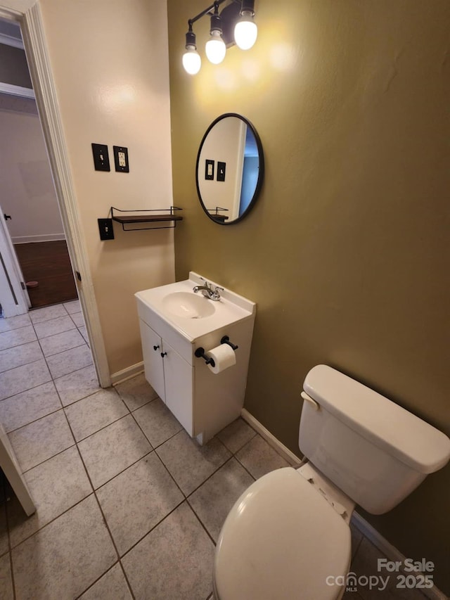 bathroom featuring tile patterned floors, vanity, and toilet